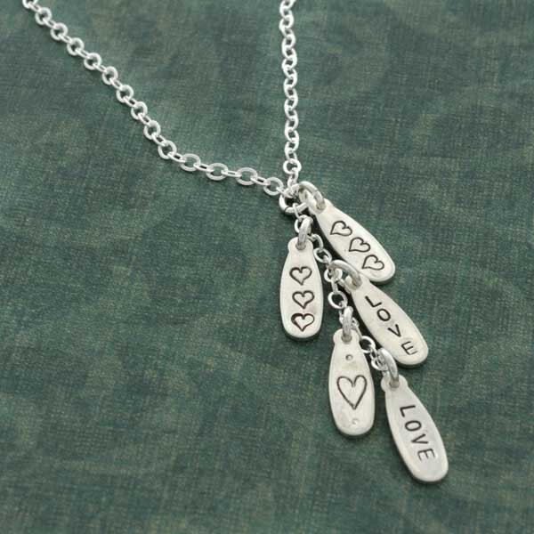 Silver Cascade Necklace with tear shaped charms stamped with hearts alternating along the chain, from Heart On Your Wrist