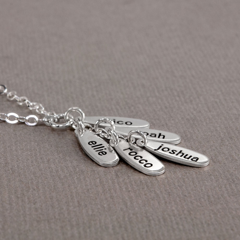 Side view of cascade necklace with kids names on each charm.