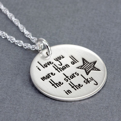 A silver necklace with a 3/4" disc engraved with a star and "I Love You More Than All The Stars In The Sky"