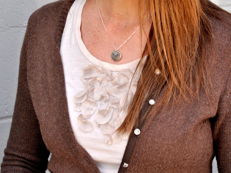 Mothers Hug Locket on Mode Model wearing Mothers Hug silver locket with engraved heart drawing on the front