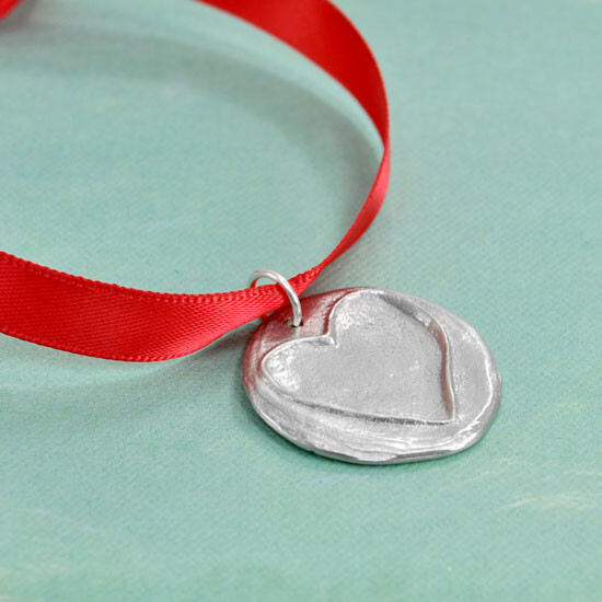 Add your handwriting or stamped message and/or date on the back Christmas ornament with a shiny fine pewter disc (1.25") with a raised heart, hung on a red ribbon