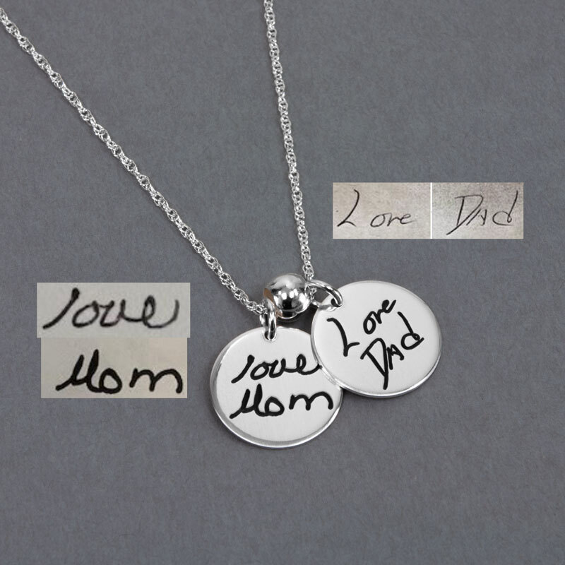 Charms showing more than one handwriting source Round silver circle charms with Love Mom and Love Dad engraved on them with their actual handwriting