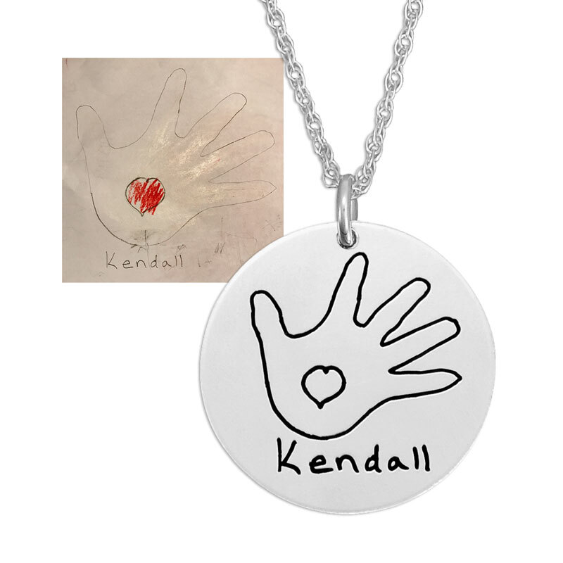 Child's drawing of her hand and a heart on a silver disc necklace